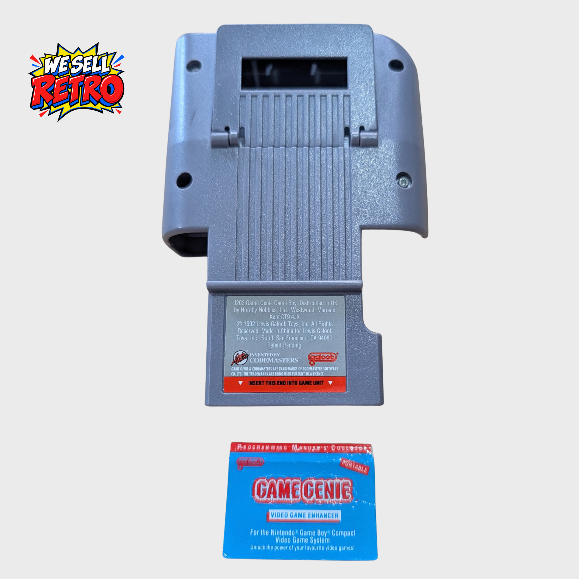 Galoob Game Genie for Nintendo Game Boy – With Programming Manual and Codebook Game Boy Game Genie rear beside its Programming Manual and Codebook
